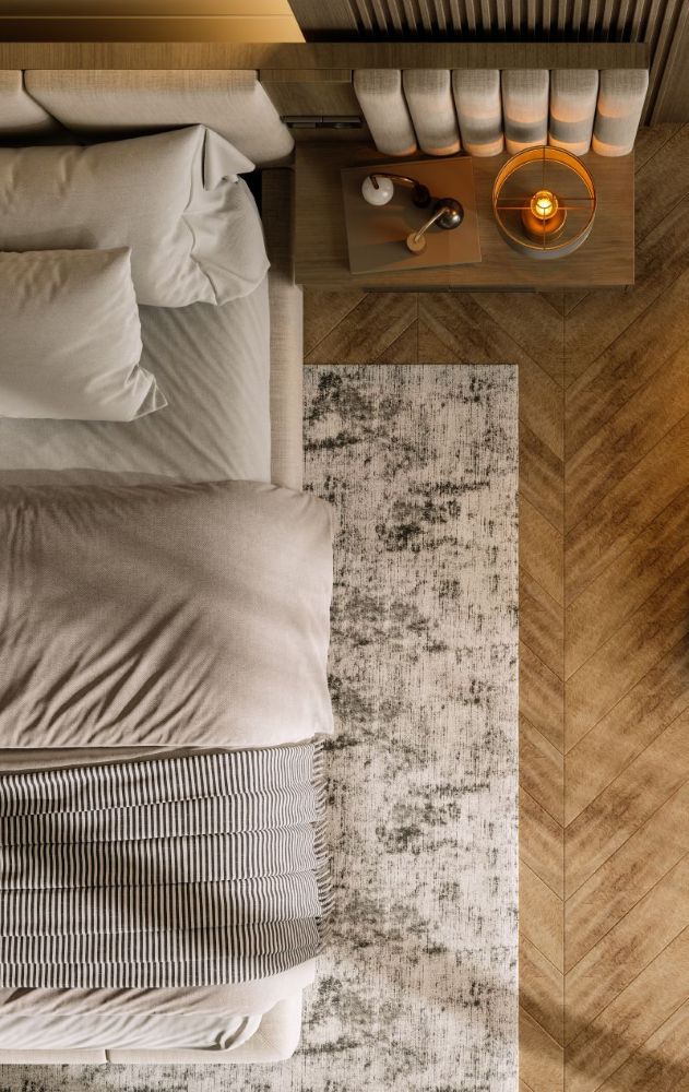 Bedroom with herringbone hardwood and area rug